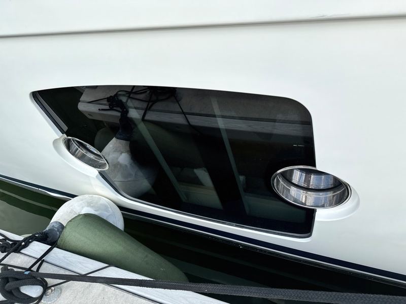 A fitted window set into a white hull.
