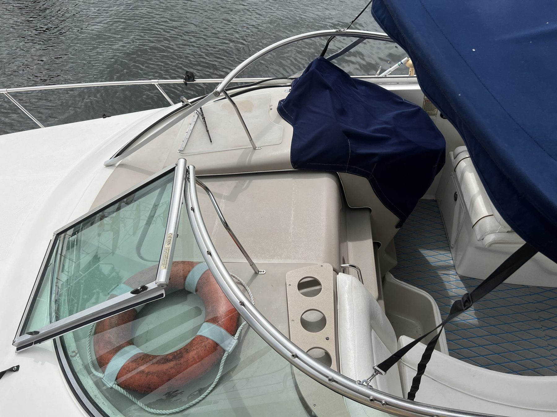 An express cruiser windshield, wrapped around the helm.